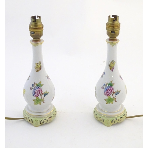 132 - A pair of Herend pottery table lamps decorated with flowers, foliage and butterflies. Marked under. ... 