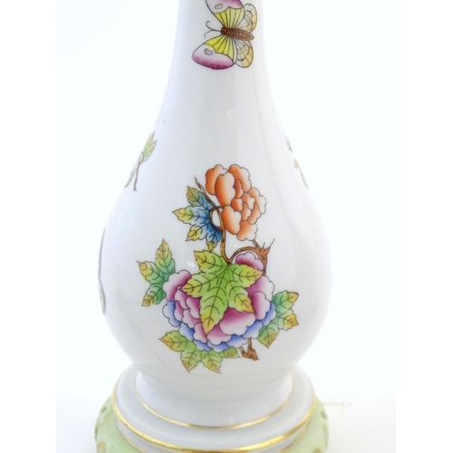 132 - A pair of Herend pottery table lamps decorated with flowers, foliage and butterflies. Marked under. ... 