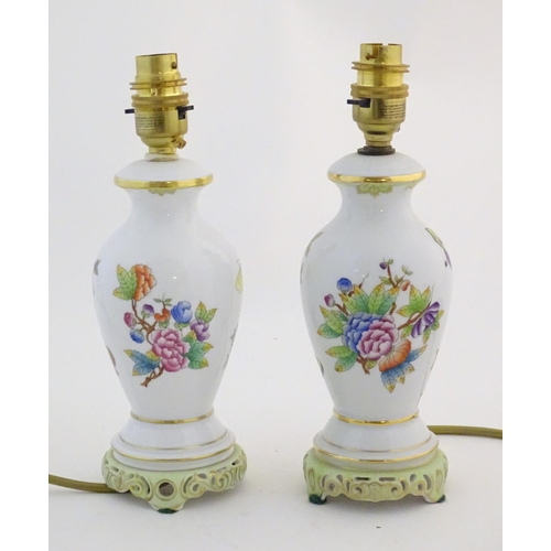 133 - A pair of Herend pottery table lamps decorated with flowers, foliage and butterflies. Marked under. ... 