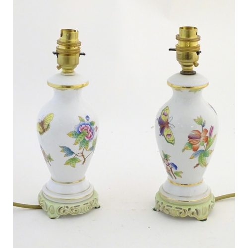 133 - A pair of Herend pottery table lamps decorated with flowers, foliage and butterflies. Marked under. ... 