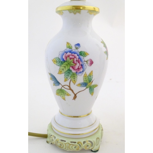 133 - A pair of Herend pottery table lamps decorated with flowers, foliage and butterflies. Marked under. ... 