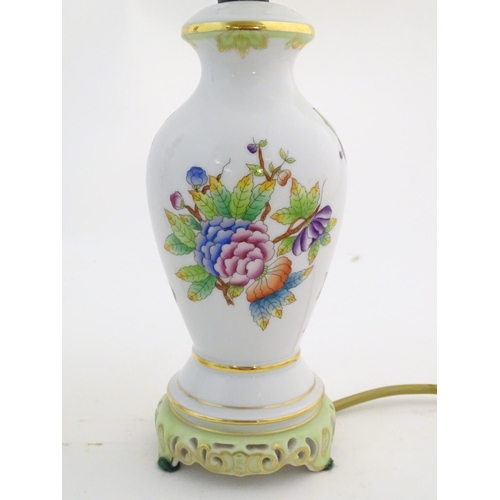 133 - A pair of Herend pottery table lamps decorated with flowers, foliage and butterflies. Marked under. ... 