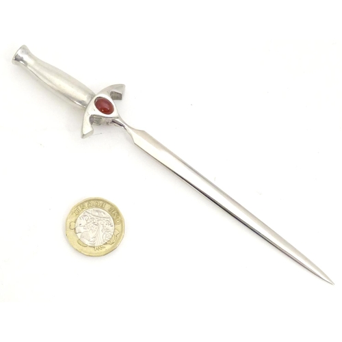 1831 - A 20thC letter opener modelled as a sword with cabochon detail to hilt. Approx. 6