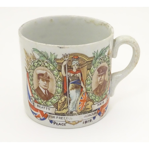 1015 - Militaria: an early 20thC ceramic mug with First World War / WWI / World War 1 commemorative decorat... 