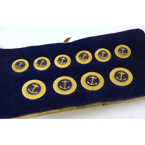 1027 - Militaria: a boxed presentation set of naval tunic buttons, each with anchor decoration, the case in... 