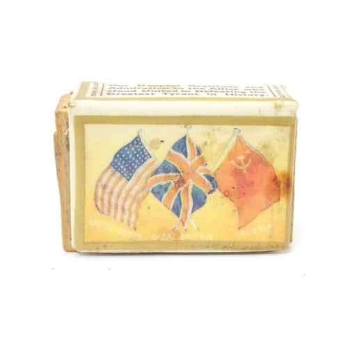 1033 - Militaria: a tin matchbox cover with WWII / World War 2 / Second World War commemorative decoration,... 