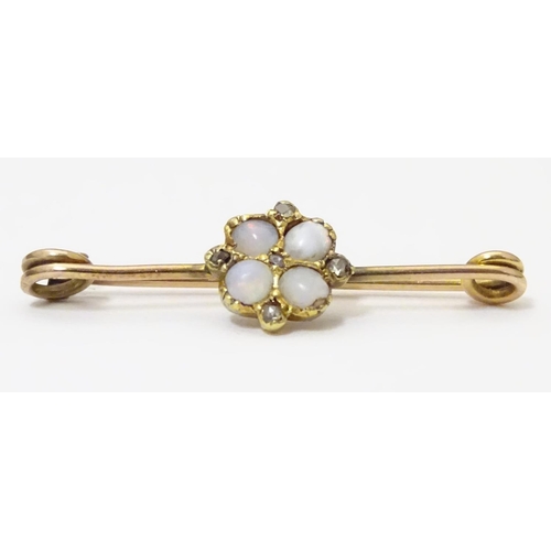 923 - A yellow metal bar brooch set with opals and diamonds. Approx. 1 1/4