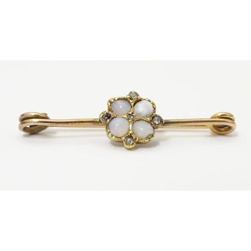 923 - A yellow metal bar brooch set with opals and diamonds. Approx. 1 1/4