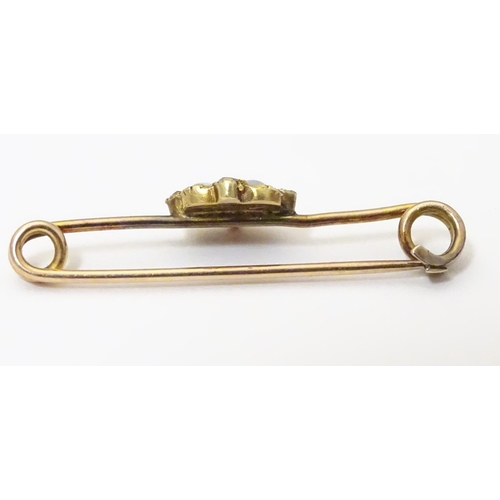 923 - A yellow metal bar brooch set with opals and diamonds. Approx. 1 1/4