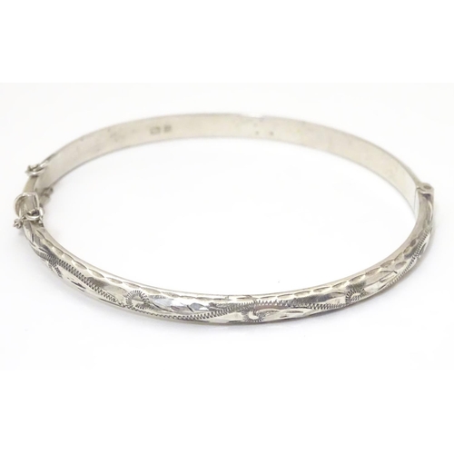 926 - A silver bracelet of bangle form, hallmarked Birmingham 1988