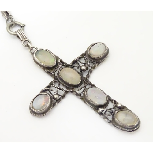 930 - An Arts & Crafts white metal pendant of cross form set with five opalescent moonstone cabochon, with... 