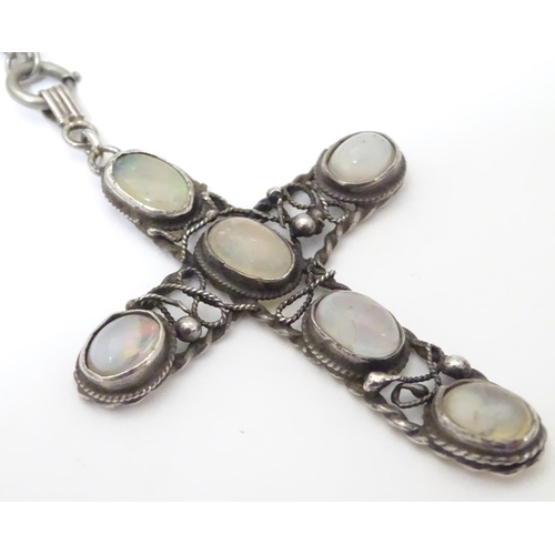 930 - An Arts & Crafts white metal pendant of cross form set with five opalescent moonstone cabochon, with... 