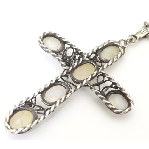 930 - An Arts & Crafts white metal pendant of cross form set with five opalescent moonstone cabochon, with... 