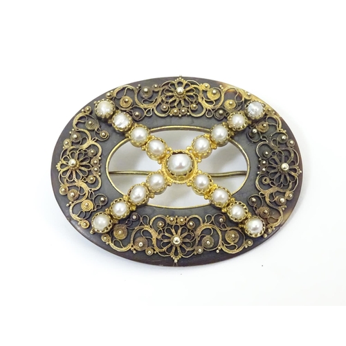 934 - A Victorian tortoiseshell brooch with gilt metal filigree detail and seed pearls. Approx. 1 1/2