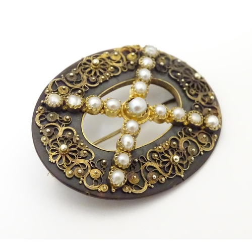 934 - A Victorian tortoiseshell brooch with gilt metal filigree detail and seed pearls. Approx. 1 1/2