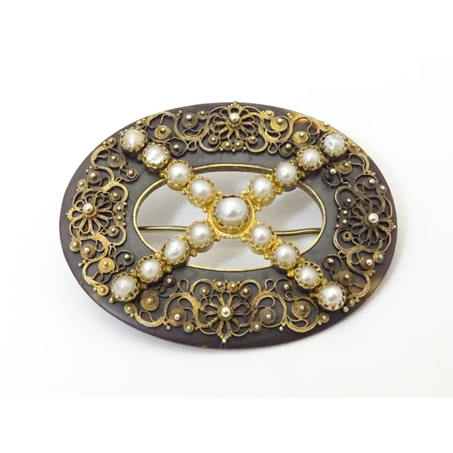 934 - A Victorian tortoiseshell brooch with gilt metal filigree detail and seed pearls. Approx. 1 1/2