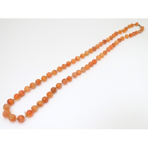 940 - A vintage bead necklace of orange agate hardstone beads. Approx. 32