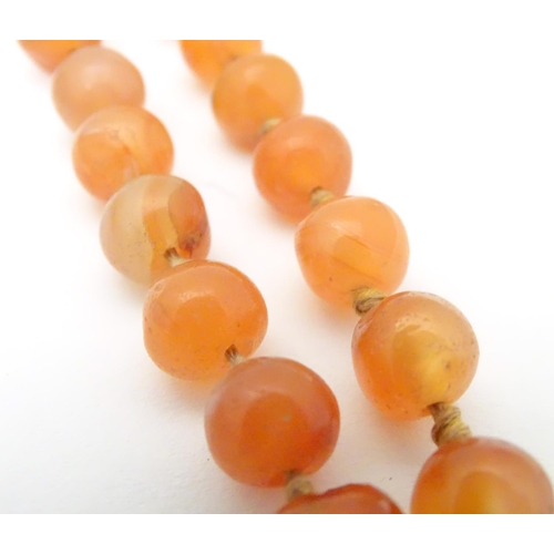 940 - A vintage bead necklace of orange agate hardstone beads. Approx. 32