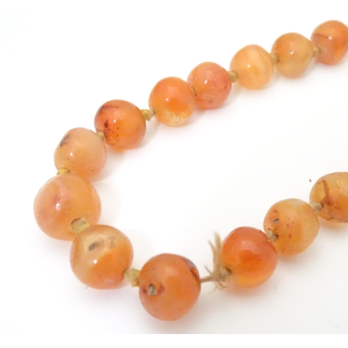 940 - A vintage bead necklace of orange agate hardstone beads. Approx. 32