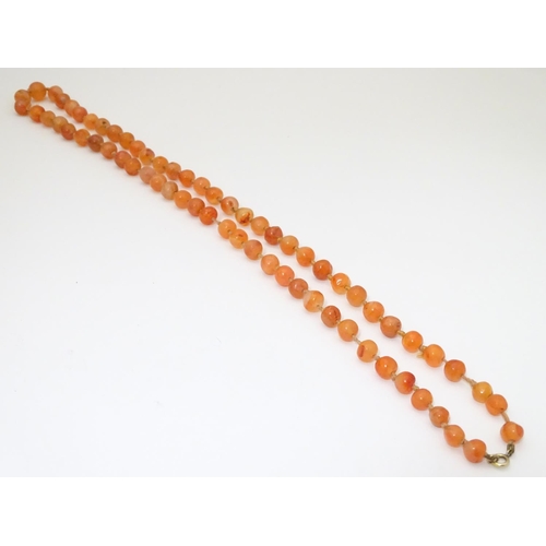 940 - A vintage bead necklace of orange agate hardstone beads. Approx. 32