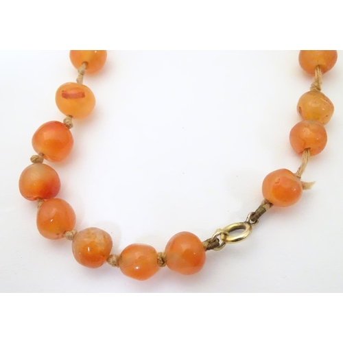 940 - A vintage bead necklace of orange agate hardstone beads. Approx. 32