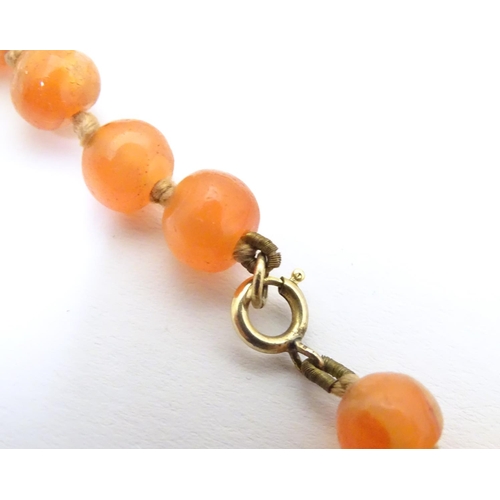 940 - A vintage bead necklace of orange agate hardstone beads. Approx. 32