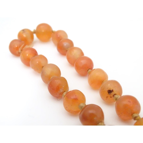 940 - A vintage bead necklace of orange agate hardstone beads. Approx. 32