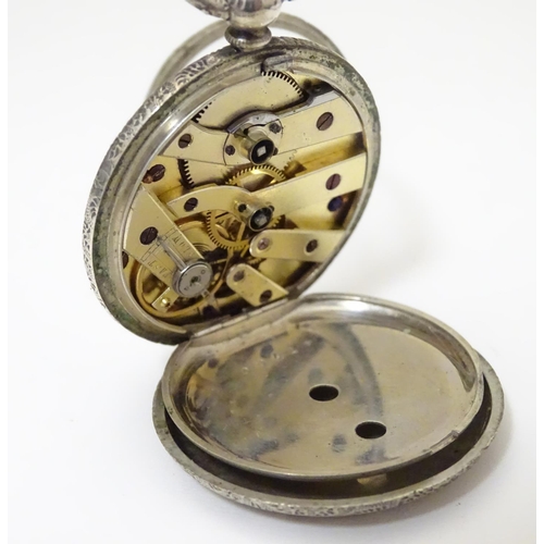 968 - A carved pocket watch travelling case / stand. Together with a pocket / fob watch. (2)