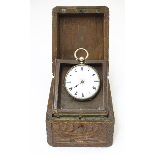 968 - A carved pocket watch travelling case / stand. Together with a pocket / fob watch. (2)