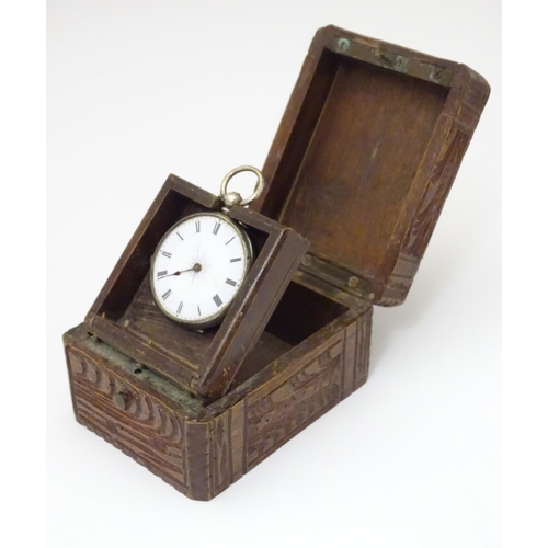 968 - A carved pocket watch travelling case / stand. Together with a pocket / fob watch. (2)