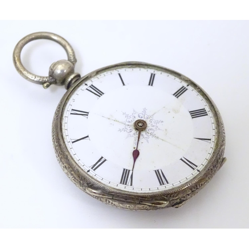 968 - A carved pocket watch travelling case / stand. Together with a pocket / fob watch. (2)