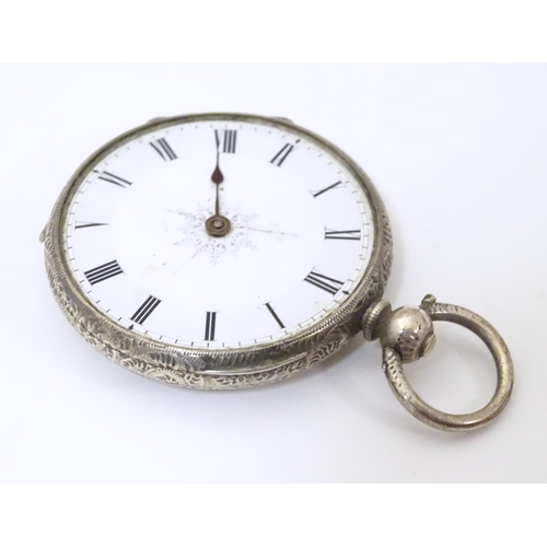 968 - A carved pocket watch travelling case / stand. Together with a pocket / fob watch. (2)