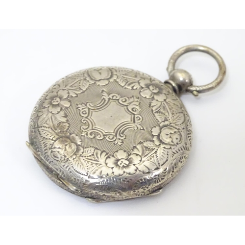 968 - A carved pocket watch travelling case / stand. Together with a pocket / fob watch. (2)