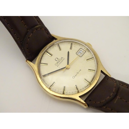 974 - A mid 20thC Omega Geneva automatic chronometer wrist watch with a 9ct gold case. The movement stampe... 