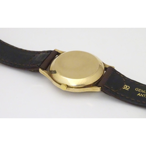 974 - A mid 20thC Omega Geneva automatic chronometer wrist watch with a 9ct gold case. The movement stampe... 