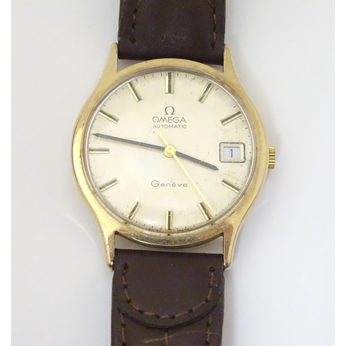 974 - A mid 20thC Omega Geneva automatic chronometer wrist watch with a 9ct gold case. The movement stampe... 