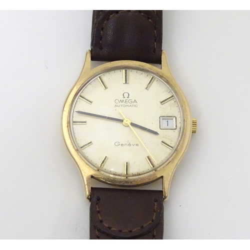 974 - A mid 20thC Omega Geneva automatic chronometer wrist watch with a 9ct gold case. The movement stampe... 