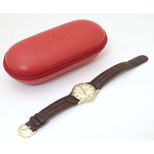 974 - A mid 20thC Omega Geneva automatic chronometer wrist watch with a 9ct gold case. The movement stampe... 