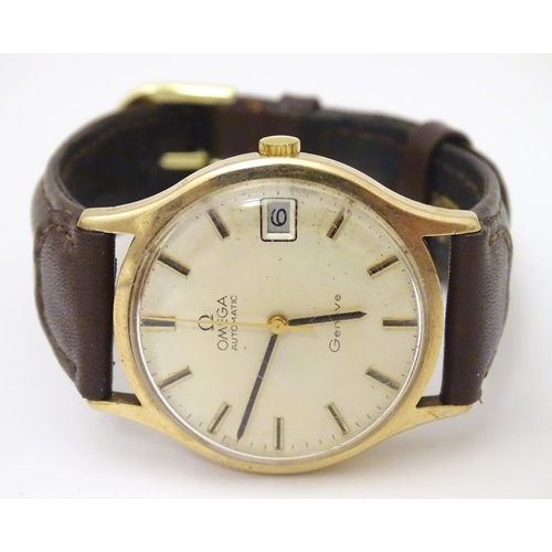 974 - A mid 20thC Omega Geneva automatic chronometer wrist watch with a 9ct gold case. The movement stampe... 