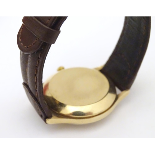 974 - A mid 20thC Omega Geneva automatic chronometer wrist watch with a 9ct gold case. The movement stampe... 