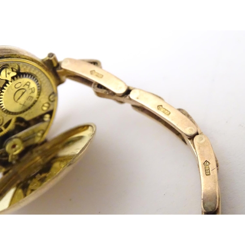 978A - A ladies 9ct gold wrist watch with enamel dial, the case stamped D&R 20152, dial approx. 3/4