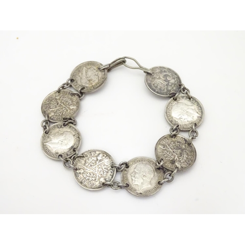 979 - An early 20thC coin bracelet, linked by eight Edwardian 3d threepenny coins, 7