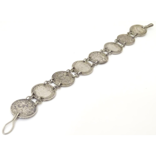 979 - An early 20thC coin bracelet, linked by eight Edwardian 3d threepenny coins, 7