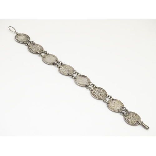 979 - An early 20thC coin bracelet, linked by eight Edwardian 3d threepenny coins, 7