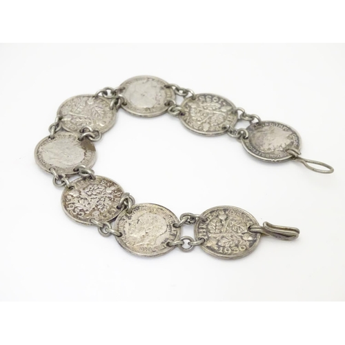 979 - An early 20thC coin bracelet, linked by eight Edwardian 3d threepenny coins, 7