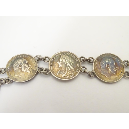 980 - An early 20thC white metal watch chain, linked by fifteen Victorian and Edwardian 3d threepenny coin... 