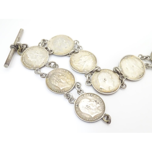 980 - An early 20thC white metal watch chain, linked by fifteen Victorian and Edwardian 3d threepenny coin... 