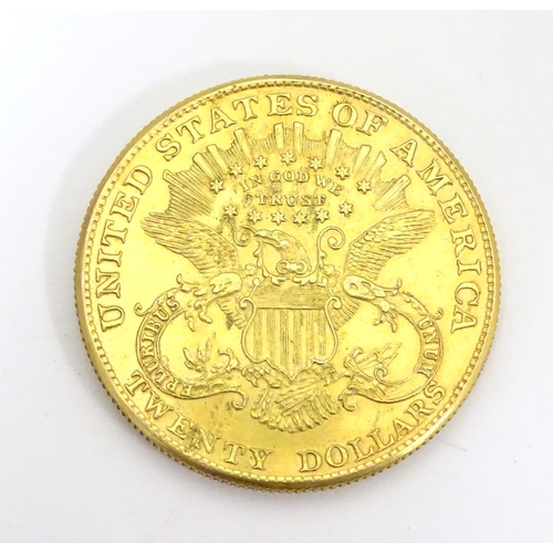 983 - Coin: An American gold 1896 twenty / 20 dollar coin. Approx. 1 3/8