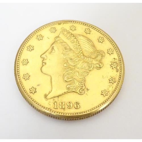 983 - Coin: An American gold 1896 twenty / 20 dollar coin. Approx. 1 3/8