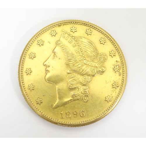 983 - Coin: An American gold 1896 twenty / 20 dollar coin. Approx. 1 3/8